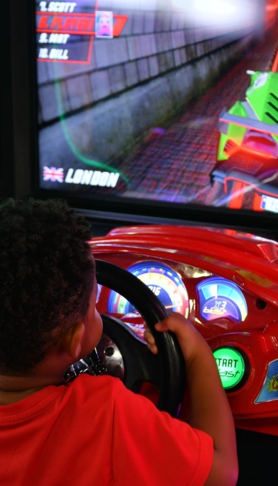 boy-playing-game-with-racing-car-screen