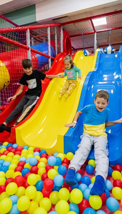 happy-kids-playing-indoor-play-center-playground-children-slides-colored-slide-into-balls-ball-pool
