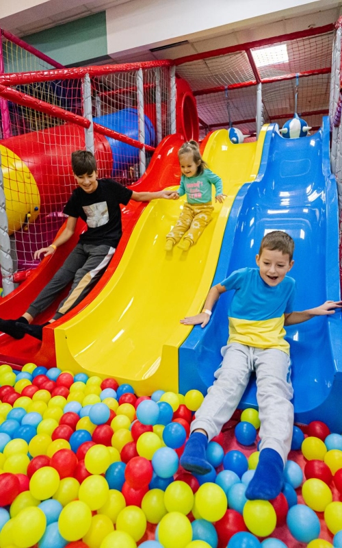 happy-kids-playing-indoor-play-center-playground-children-slides-colored-slide-into-balls-ball-pool
