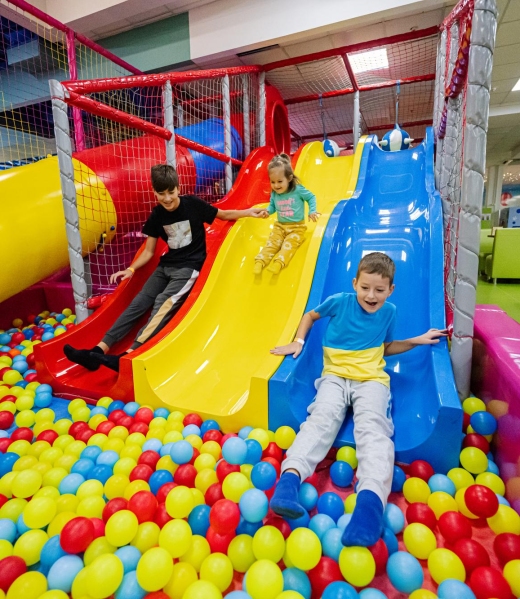 happy-kids-playing-indoor-play-center-playground-children-slides-colored-slide-into-balls-ball-pool