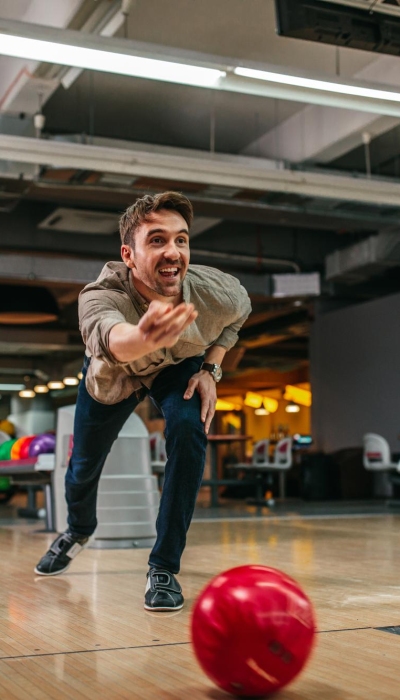 shot-attractive-young-man-throwing-bowling-ball