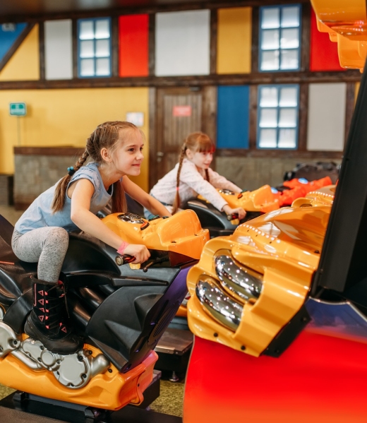 two-girls-plays-game-machine-entertainment-center