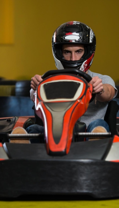 young-man-is-driving-gokart-car-with-speed-playground-racing-track-go-kart-is-popular-leisure-motor-sports